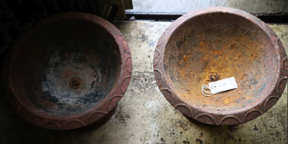A pair of Victorian cast iron campana urns, 33cm diameter